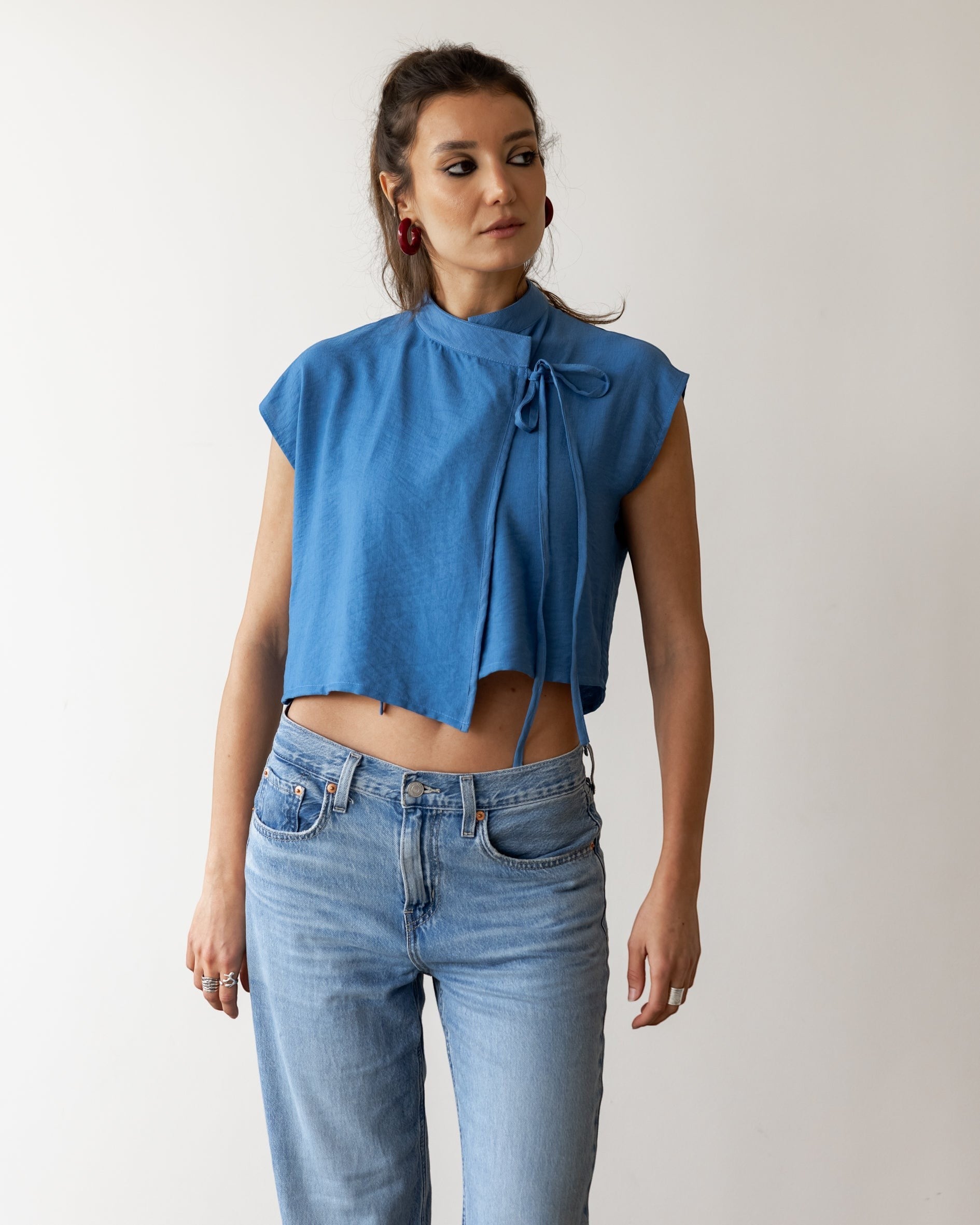 FSociety steel blue lightweight fabric wrap-front knot top with mock neck and cap sleeves.
